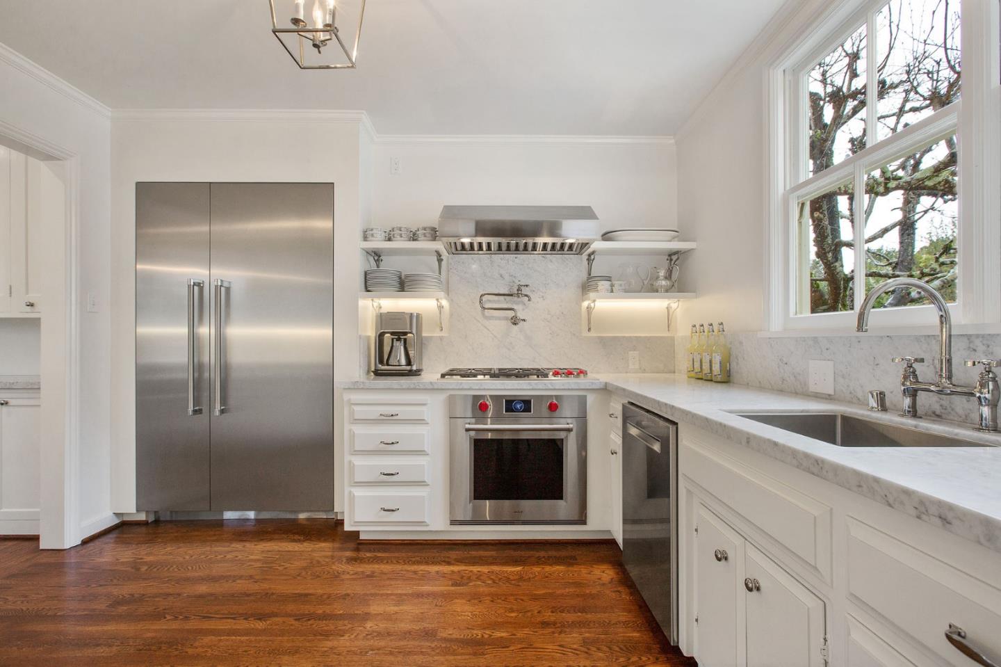 508 Roehampton Road Hillsborough, CA 94010 - Photo 22 of 50 a kitchen with stainless steel appliances granite countertop a stove a sink and a refrigerator