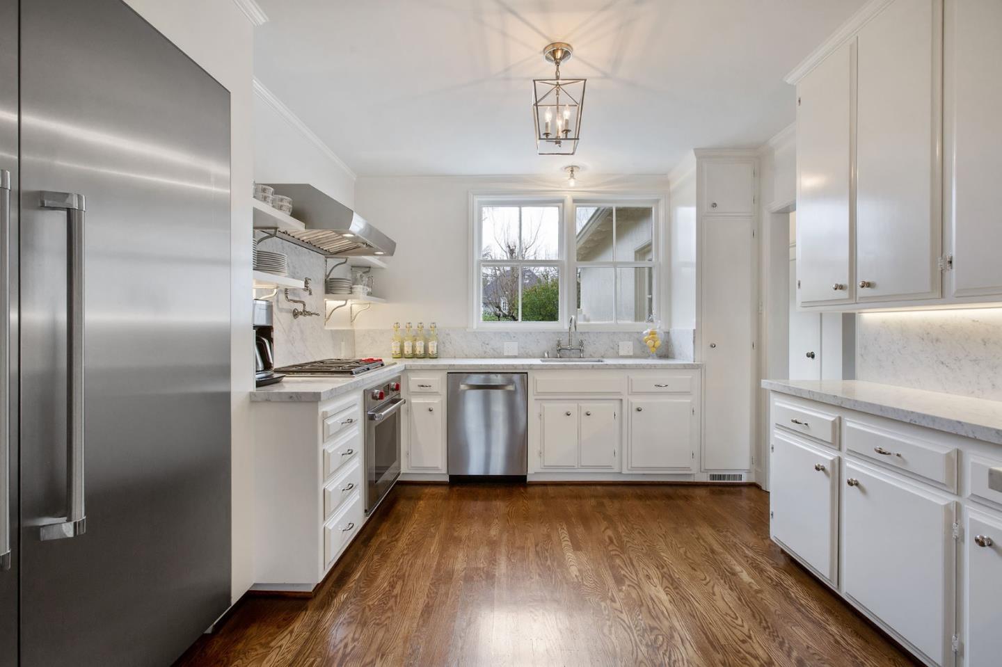 508 Roehampton Road Hillsborough, CA 94010 - Photo 24 of 50 a kitchen with sink cabinets and wooden floor