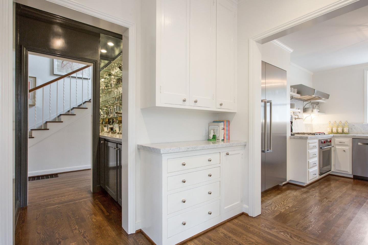 508 Roehampton Road Hillsborough, CA 94010 - Photo 28 of 50 a kitchen with white cabinets and refrigerator