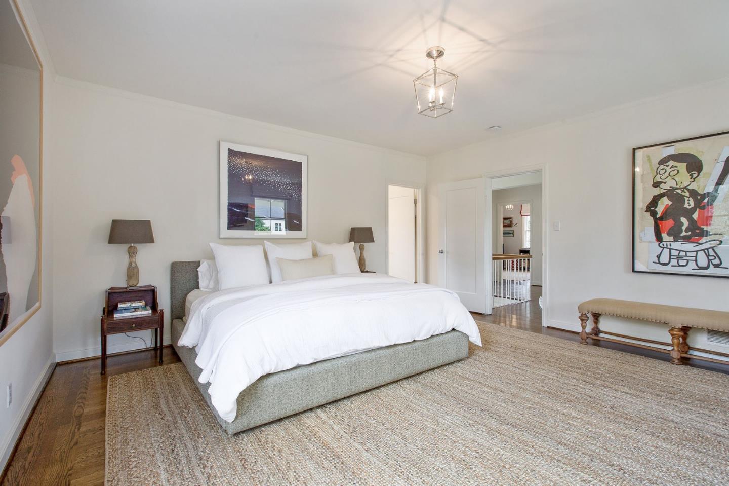 508 Roehampton Road Hillsborough, CA 94010 - Photo 33 of 50 a spacious bedroom with a bed and a chandelier