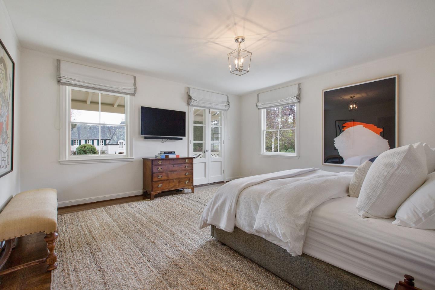 508 Roehampton Road Hillsborough, CA 94010 - Photo 34 of 50 a bedroom with a large bed a flat tv screen and a dresser