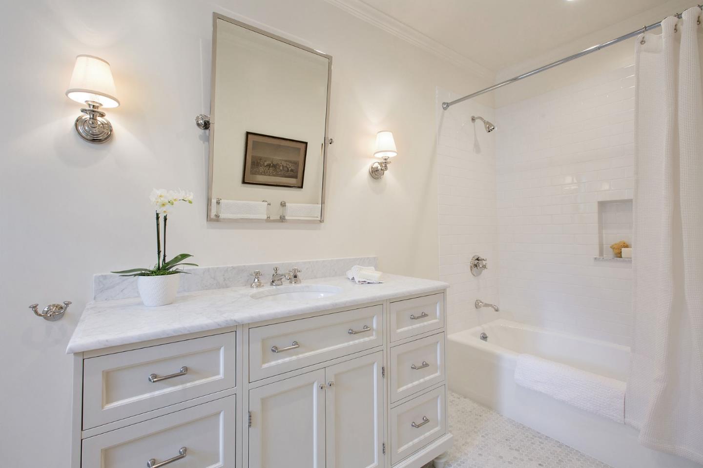 508 Roehampton Road Hillsborough, CA 94010 - Photo 49 of 50 a bathroom with a granite countertop sink a mirror a vanity and a bathtub