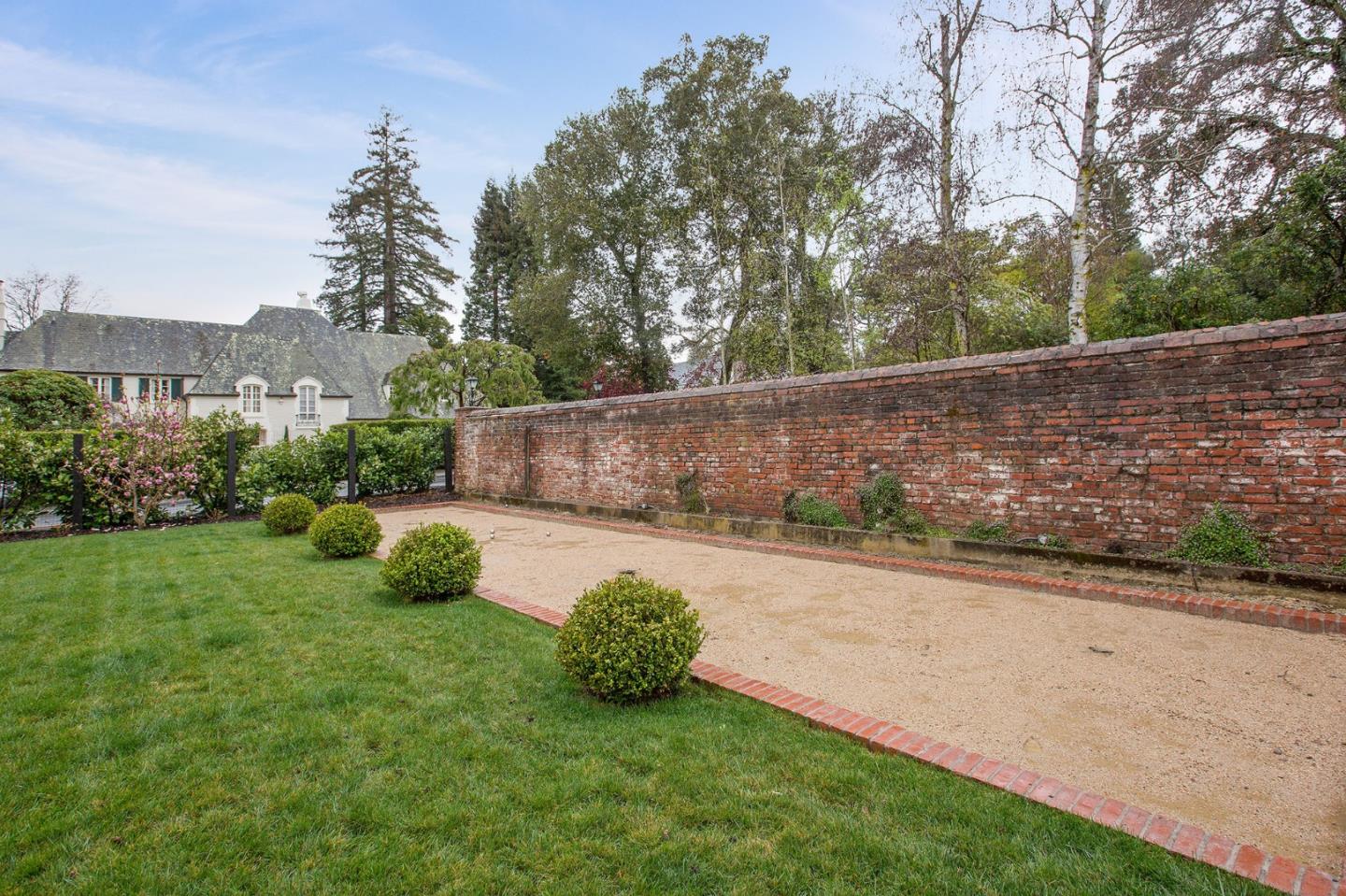 508 Roehampton Road Hillsborough, CA 94010 - Photo 8 of 50 a view of a backyard with potted plants and large trees