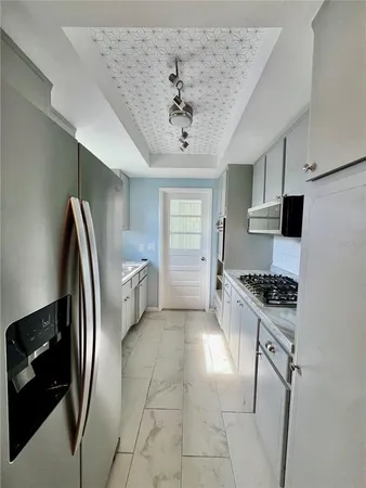 a kitchen with stainless steel appliances a refrigerator and a stove