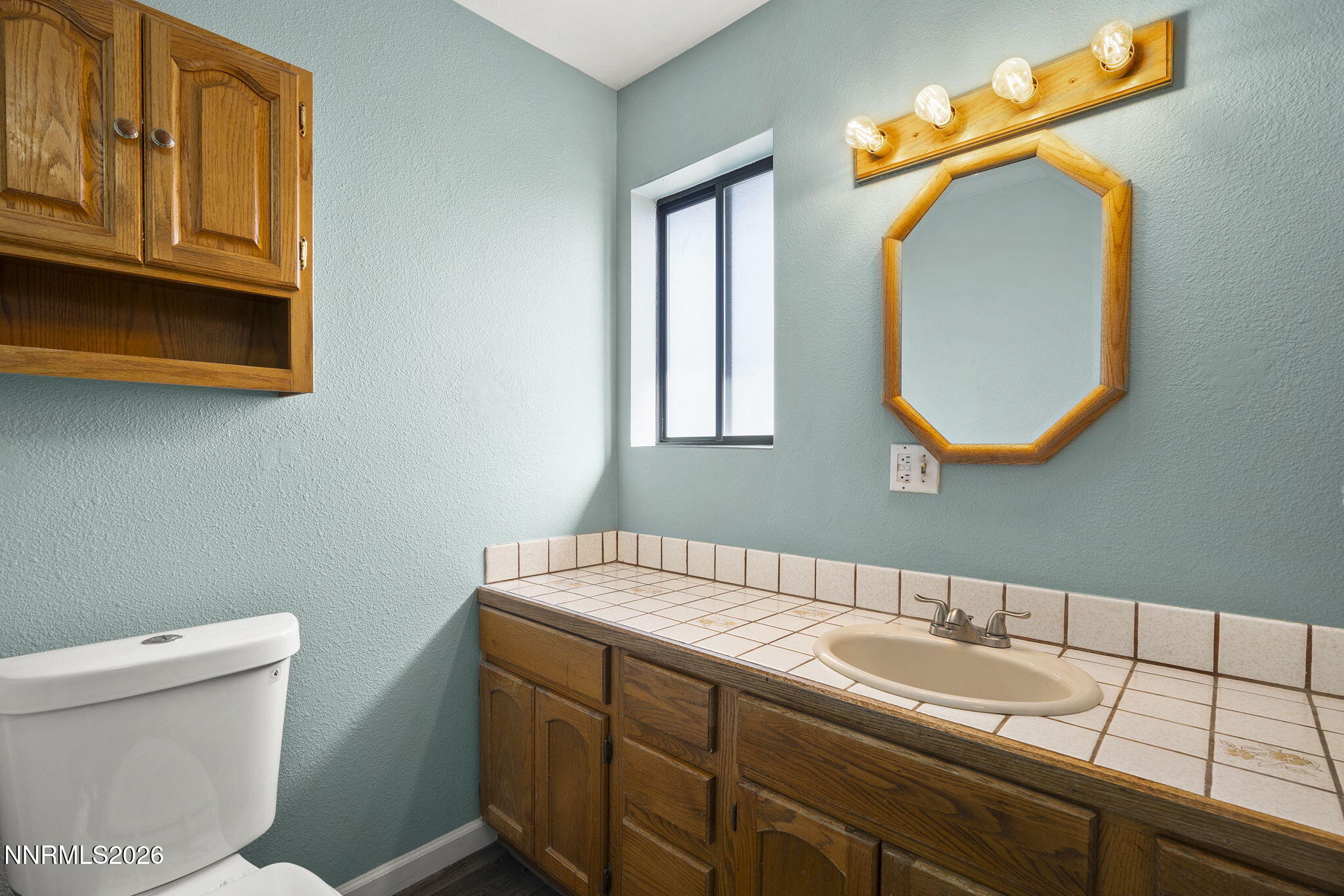 9906 North Virginia Street Reno, NV 89506 - Photo 11 of 36 a bathroom with a sink and a mirror