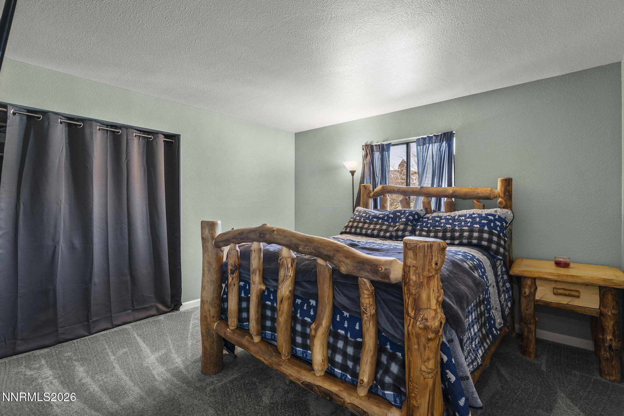 9906 North Virginia Street Reno, NV 89506 - Photo 13 of 36 a bedroom with a bed and a window