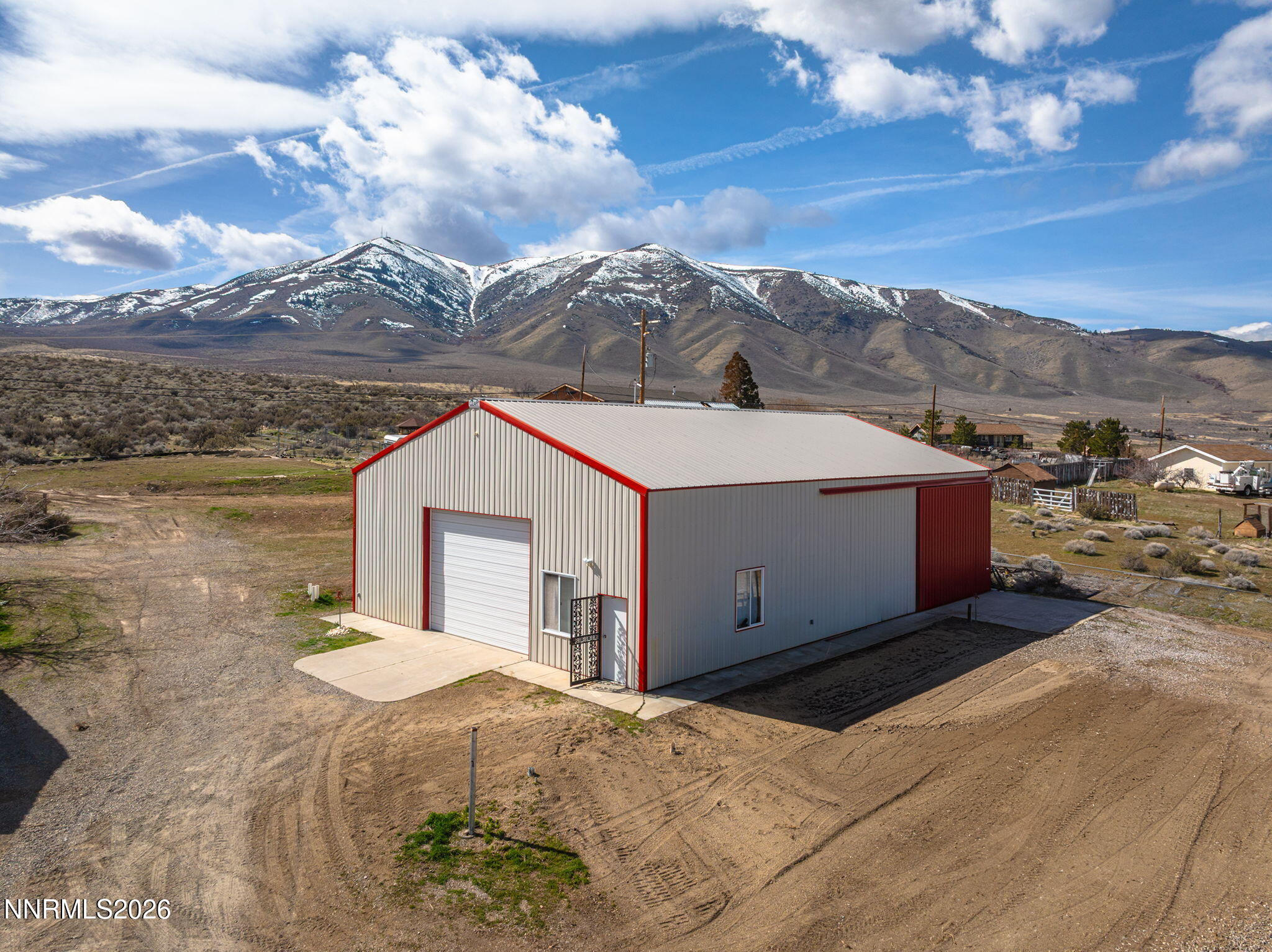 9906 North Virginia Street Reno, NV 89506 - Photo 19 of 36 a view of a white house next to a yard and mountain