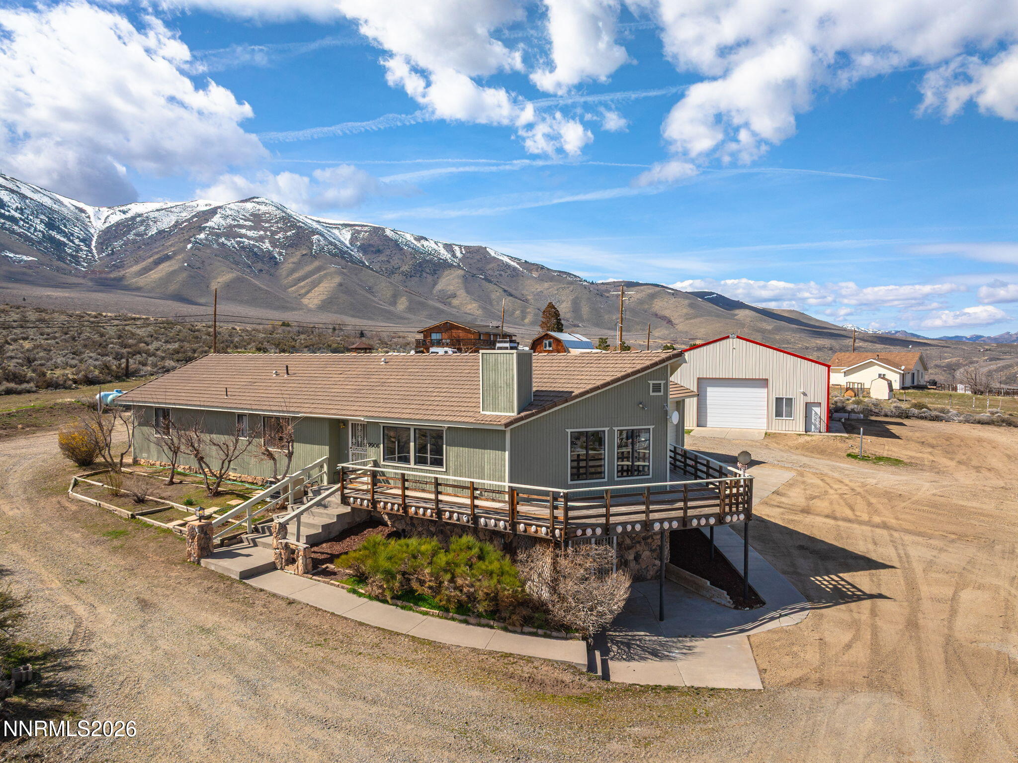 9906 North Virginia Street Reno, NV 89506 - Photo 22 of 36 a view of a white house with a swimming pool and sitting area