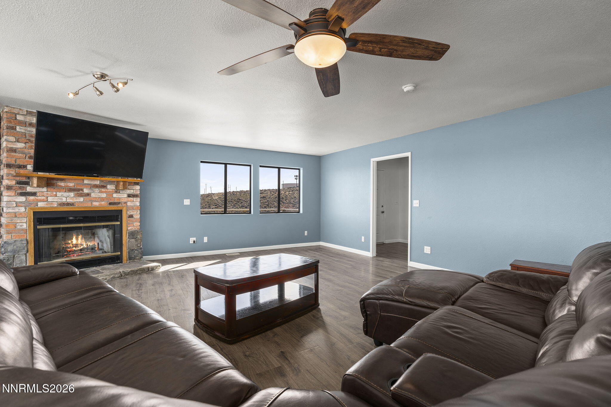 9906 North Virginia Street Reno, NV 89506 - Photo 5 of 36 a living room with furniture and a fireplace