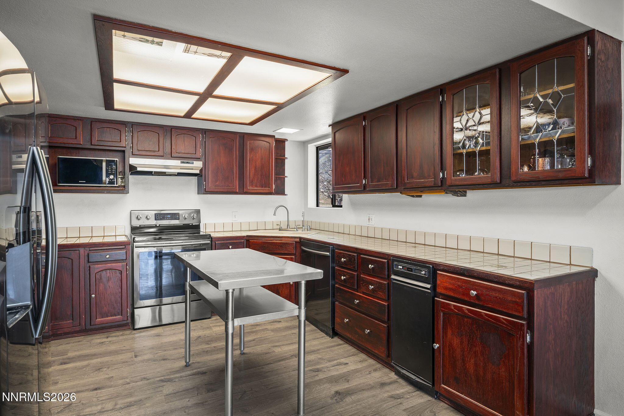 9906 North Virginia Street Reno, NV 89506 - Photo 7 of 36 a kitchen with stainless steel appliances granite countertop wooden cabinets a stove top oven a sink and dishwasher