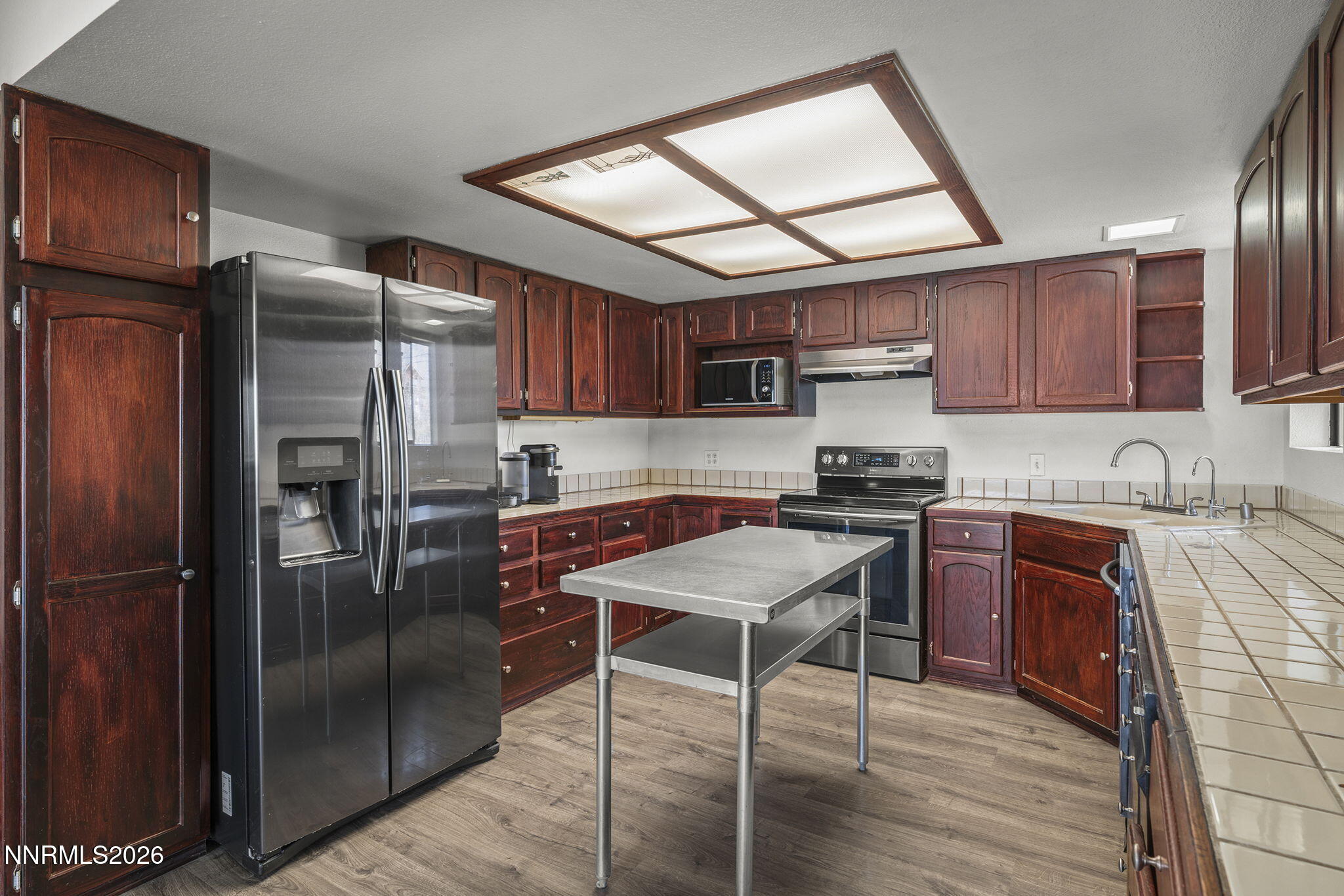9906 North Virginia Street Reno, NV 89506 - Photo 8 of 36 a kitchen with granite countertop a refrigerator stove top oven and sink