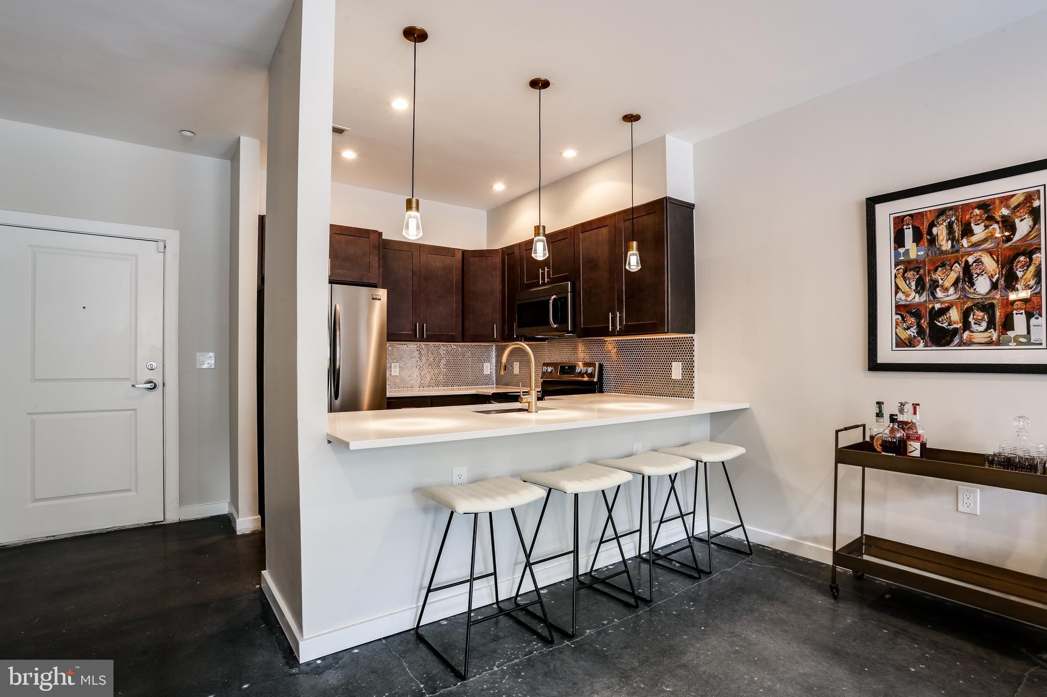 2007 Clipper Park Road, Unit 124 Baltimore, MD 21211 - Photo 13 of 35 a large kitchen with a table and chairs