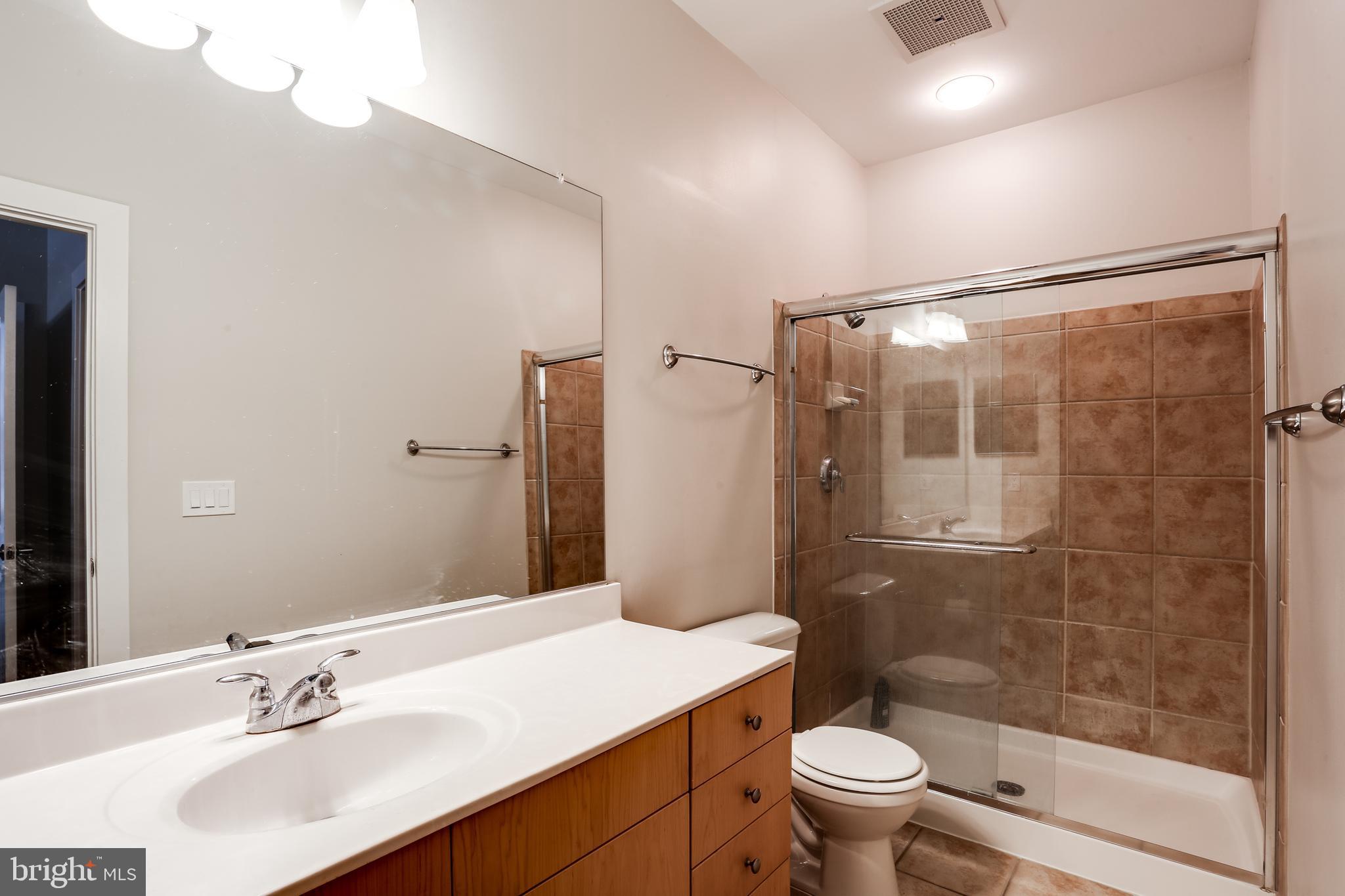 2007 Clipper Park Road, Unit 124 Baltimore, MD 21211 - Photo 18 of 35 a bathroom with a sink toilet and shower
