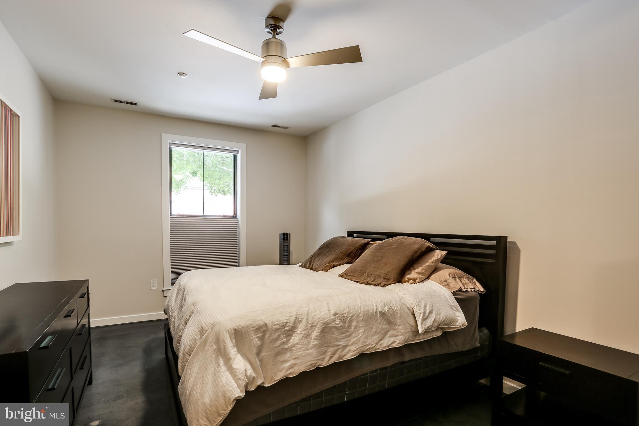 2007 Clipper Park Road, Unit 124 Baltimore, MD 21211 - Photo 20 of 35 a bedroom with a bed and a chandelier