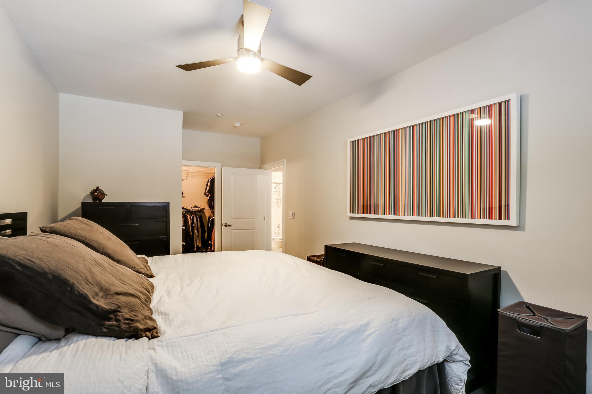 2007 Clipper Park Road, Unit 124 Baltimore, MD 21211 - Photo 23 of 35 a bedroom with a bed and a chandelier