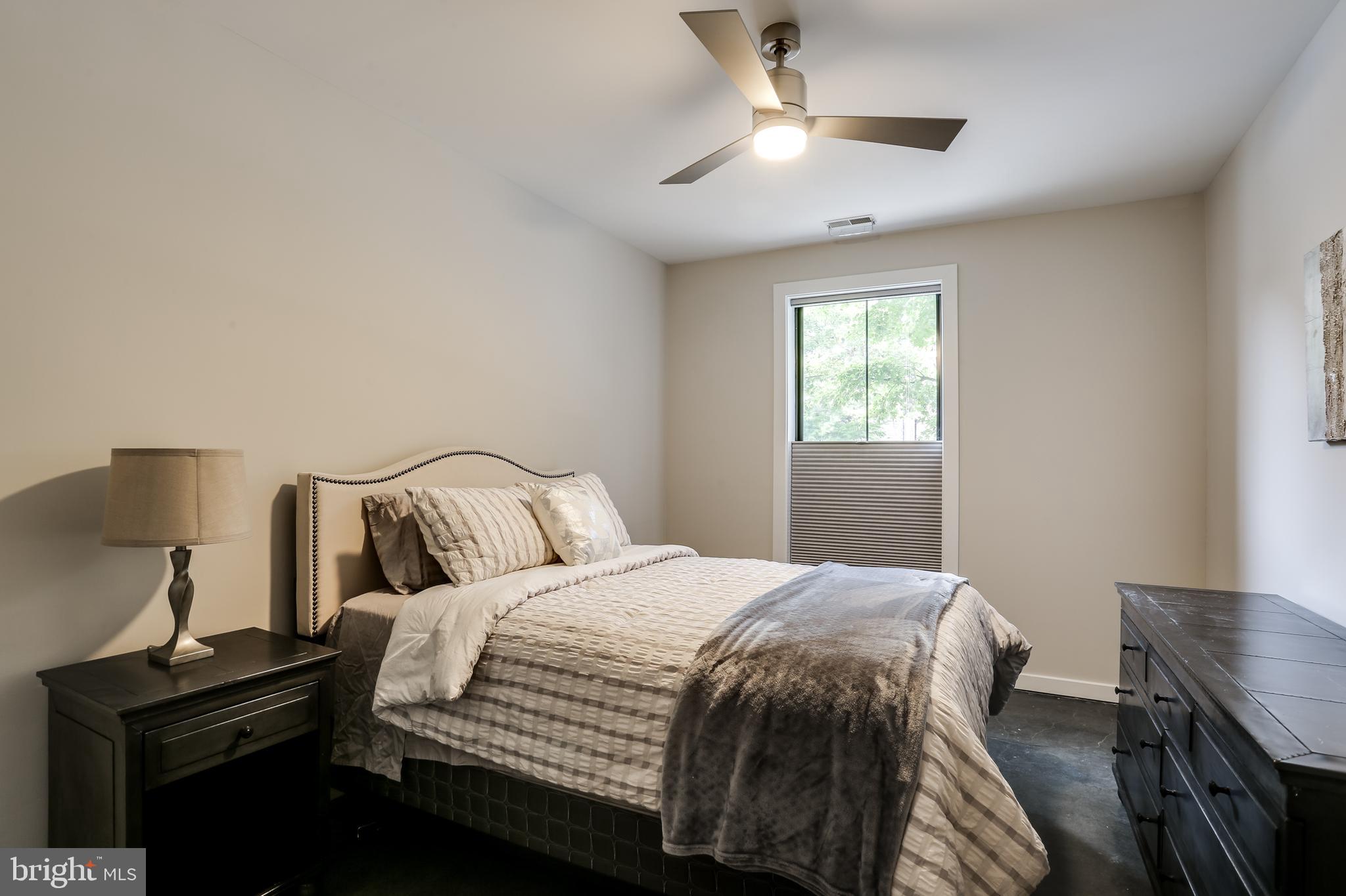 2007 Clipper Park Road, Unit 124 Baltimore, MD 21211 - Photo 25 of 35 a bedroom with a bed and a desk