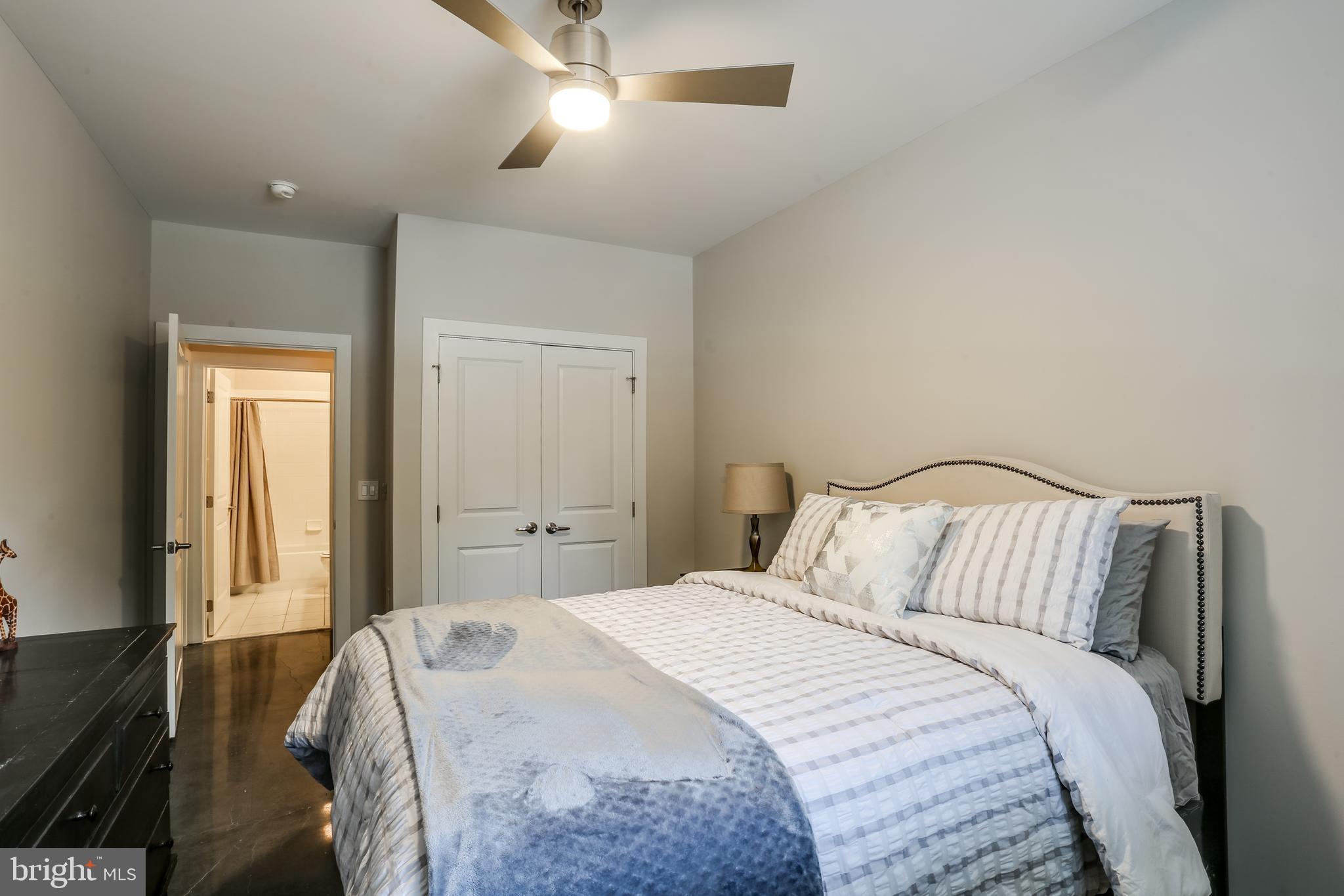 2007 Clipper Park Road, Unit 124 Baltimore, MD 21211 - Photo 27 of 35 a bedroom with a bed and a lamp