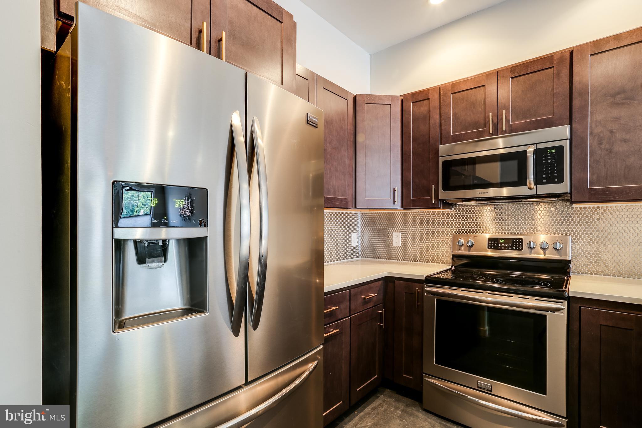 2007 Clipper Park Road, Unit 124 Baltimore, MD 21211 - Photo 6 of 35 a kitchen with stainless steel appliances and refrigerator
