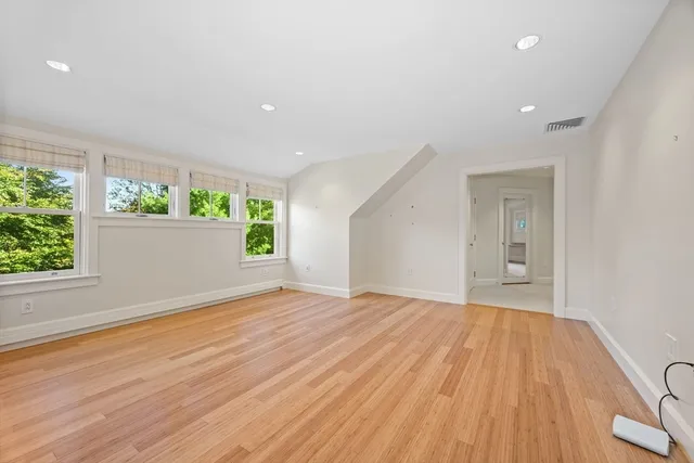 a bathroom with a sink a toilet a mirror and shower