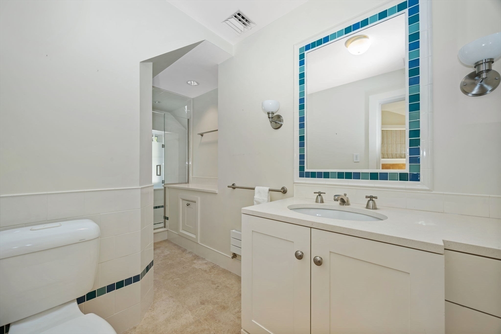29 Merrill Road Newton, MA 02459 - Photo 30 of 42 a bathroom with a sink a toilet a mirror and shower