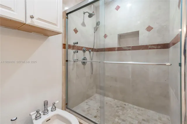 a bathroom with a shower and a sink