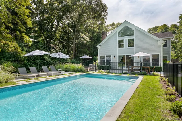 a view of a house with swimming pool and porch