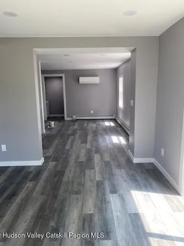a view of an empty room and wooden floor