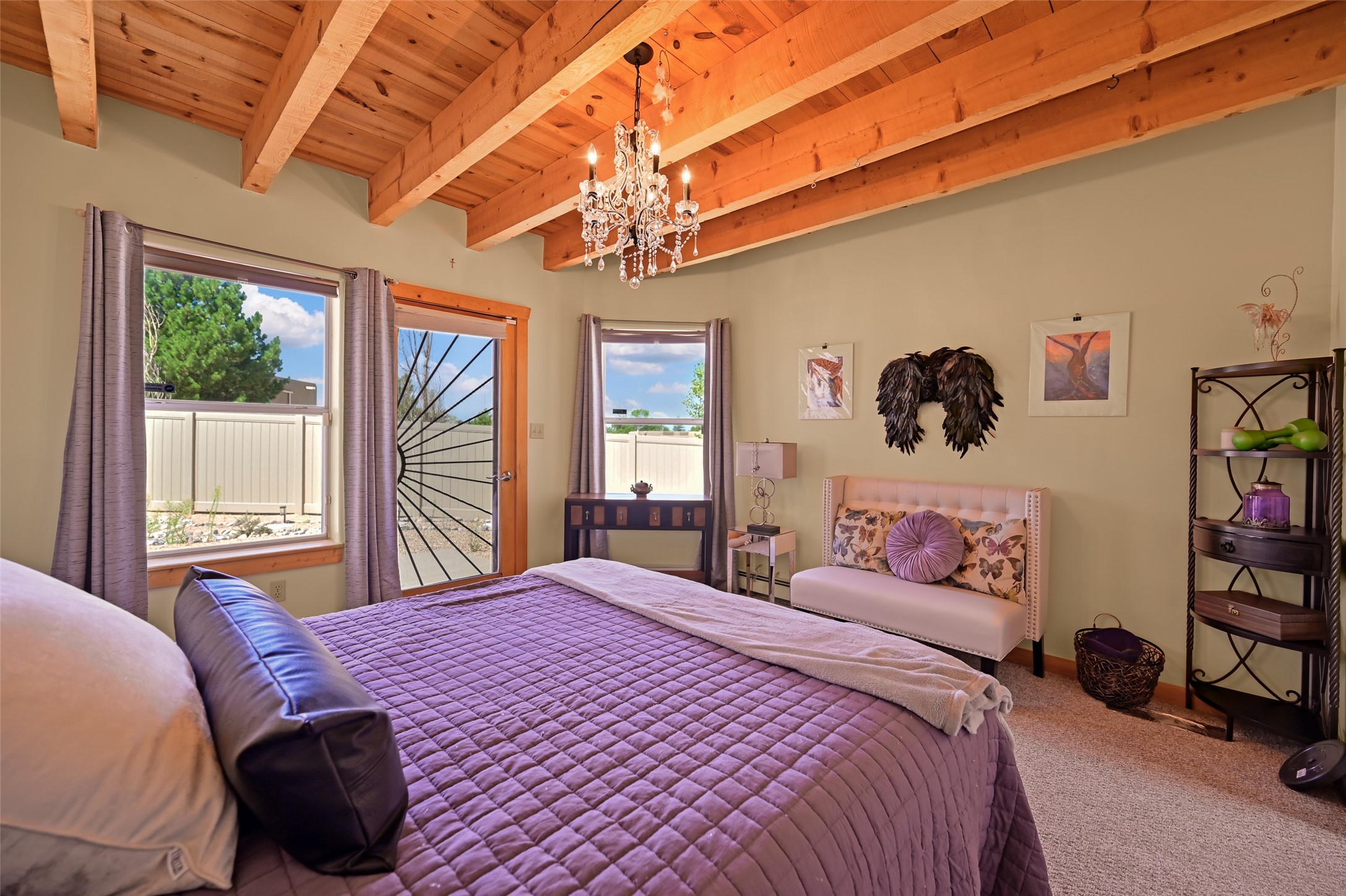 7516 Sagebrush Road Santa Fe, NM 87507 - Photo 9 of 27 Primary with wood and beam ceilings and door to back yard
