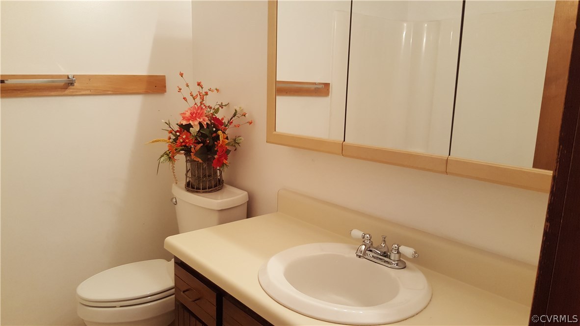 4801 Fordham Road Chesterfield, VA 23236 - Photo 8 of 15 a bathroom with a sink a toilet and mirror