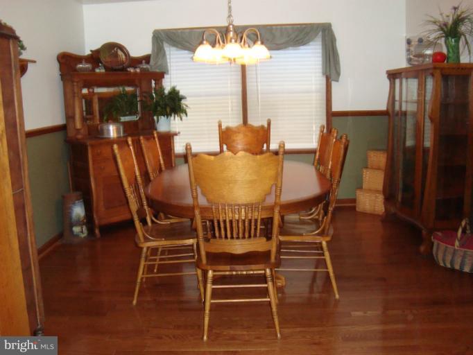 8166 N Road Severn, MD 21144 - Photo 1 of 25 a dining room with furniture and chandelier
