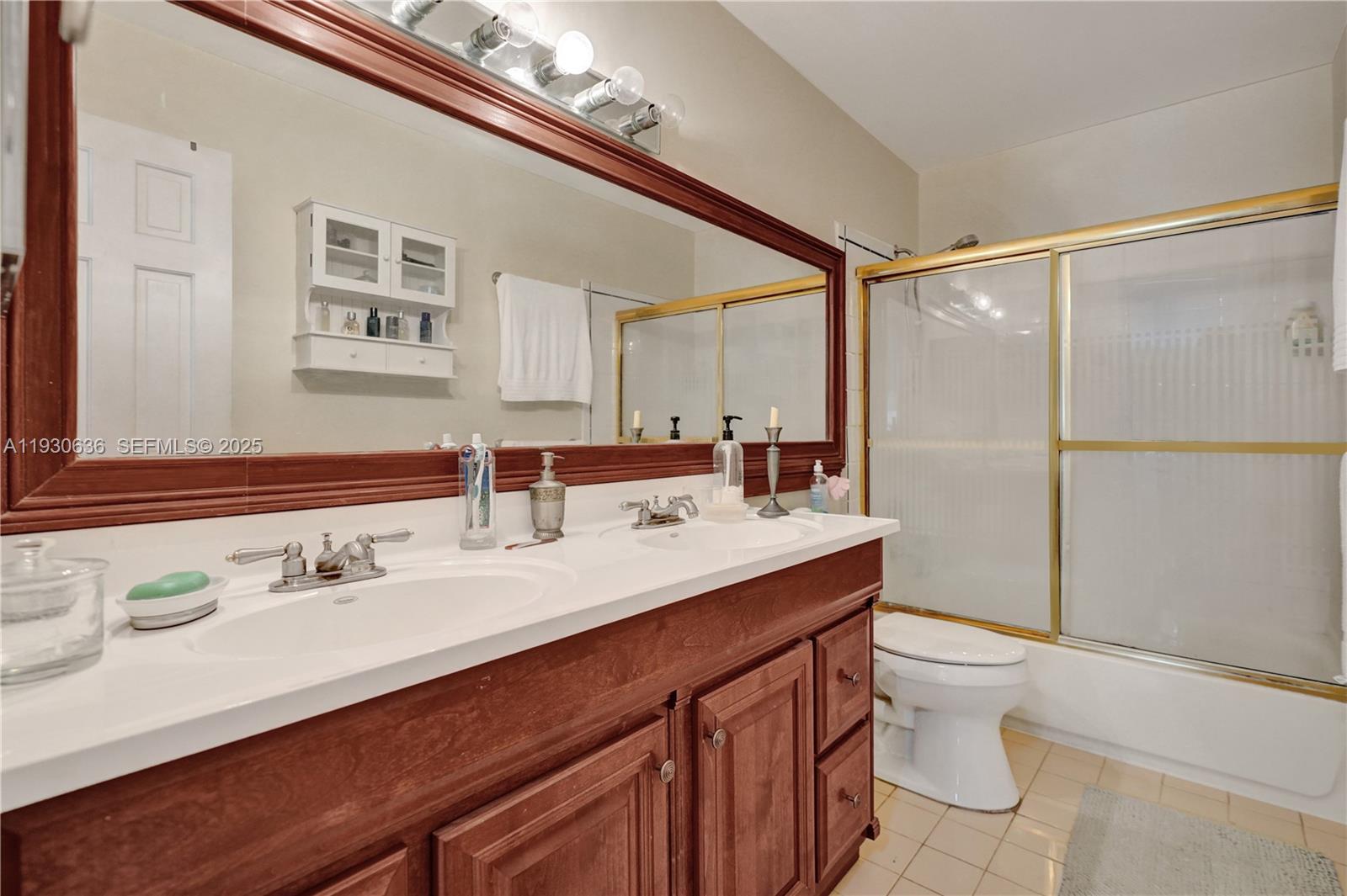 11728 Southwest 118th Terrace Miami, FL 33186 - Photo 17 of 31 a bathroom with a sink a toilet and shower