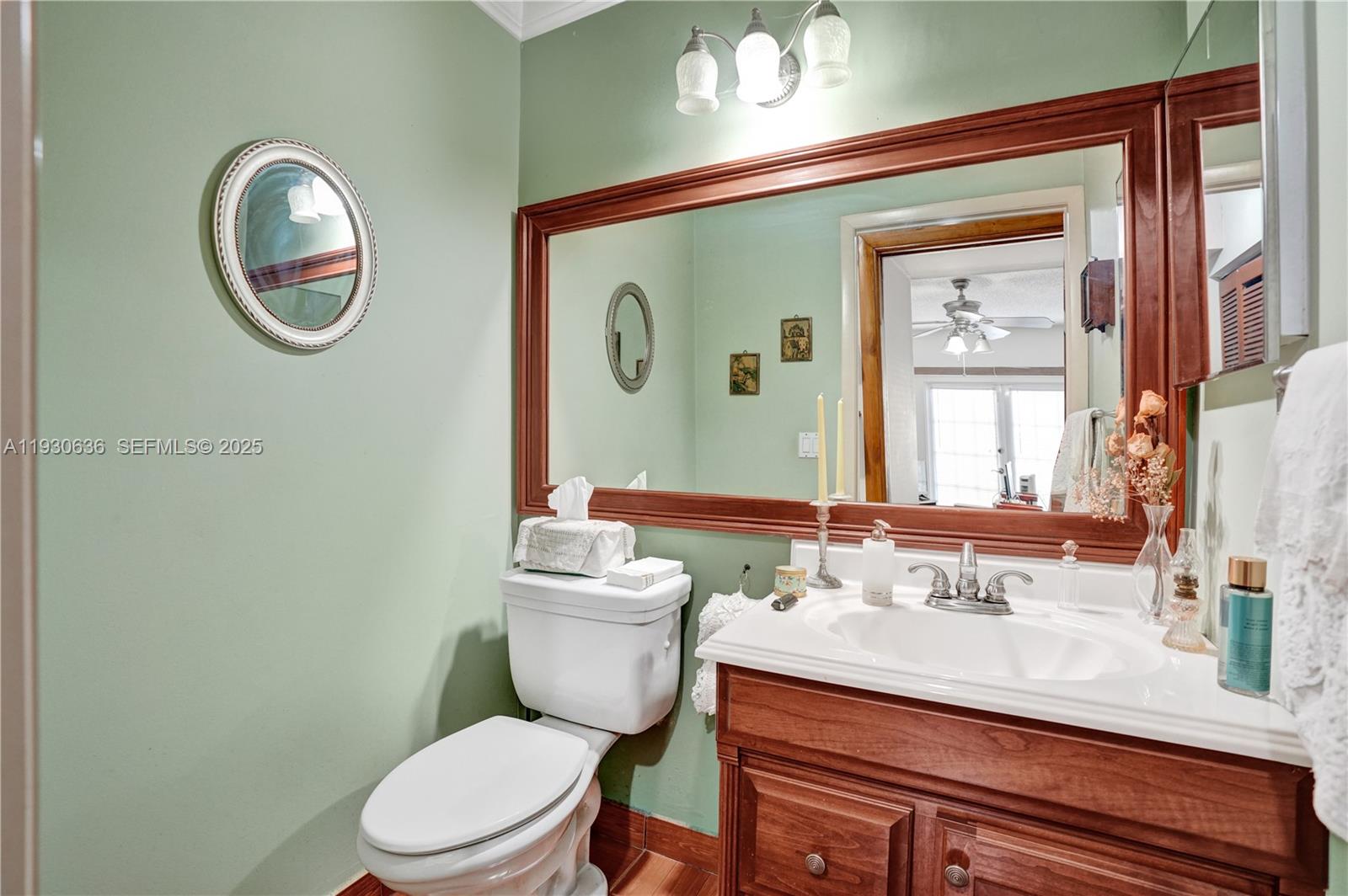 11728 Southwest 118th Terrace Miami, FL 33186 - Photo 18 of 31 a bathroom with a toilet a sink and mirror