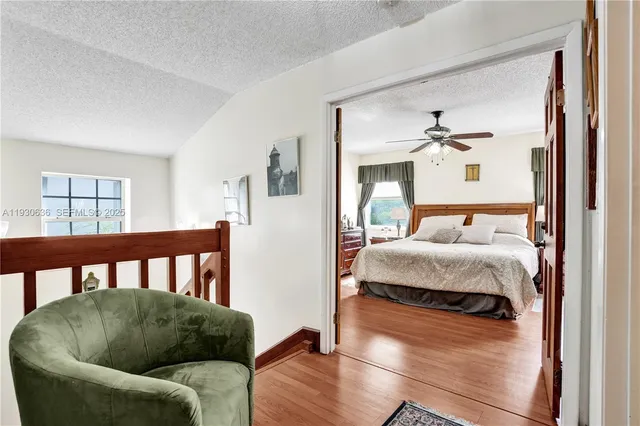 a bedroom with furniture and wooden floor