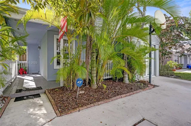 a backyard of a house with barbeque oven table and chairs
