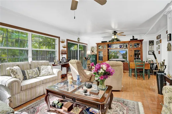 a living room with furniture and a floor to ceiling window