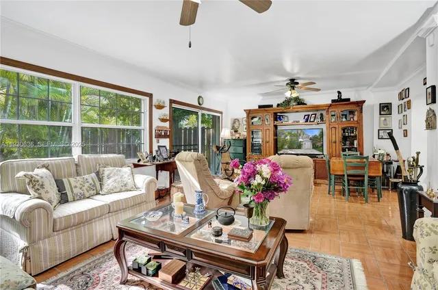 a living room with furniture and a floor to ceiling window