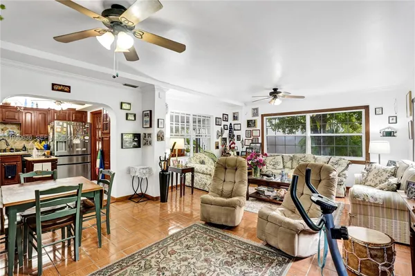 a living room with lots of furniture and a large window