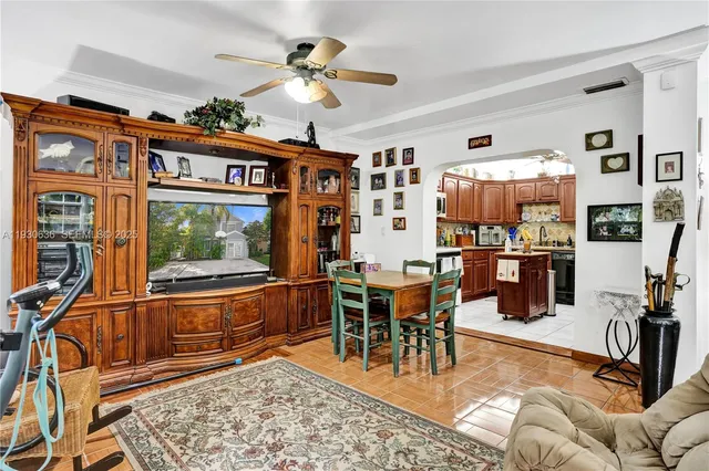 a living room with furniture a rug and a floor to ceiling window