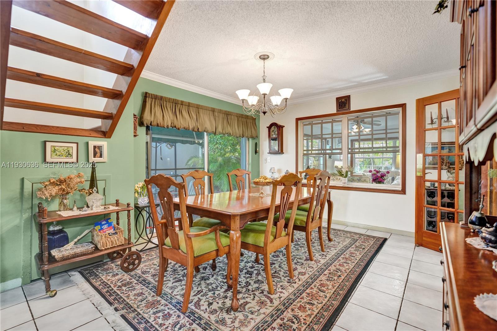 11728 Southwest 118th Terrace Miami, FL 33186 - Photo 9 of 31 a dining room with furniture a rug a rug a rug and a chandelier