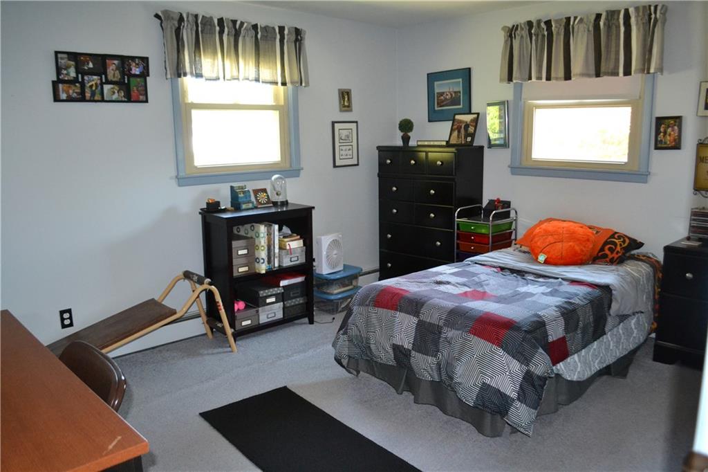 101 Locust Street Rural Valley, PA 16249 - Photo 8 of 16 a bedroom with a bed and a tv on the dresser