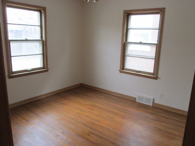 1818 Rural Street Rockford, IL 61107 - Photo 5 of 10 an empty room with wooden floor and windows