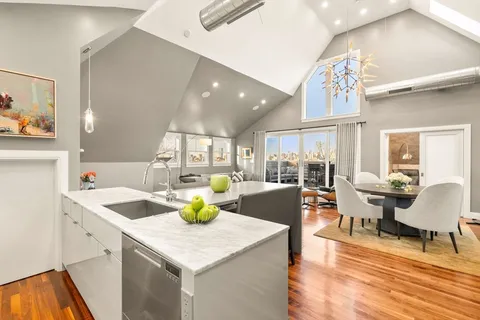 a kitchen with a sink a counter space and dining table