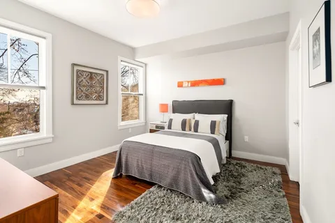 a bed room with a bed and a painting on the wall