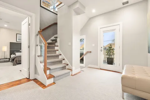a view of a livingroom with entryway and stairs