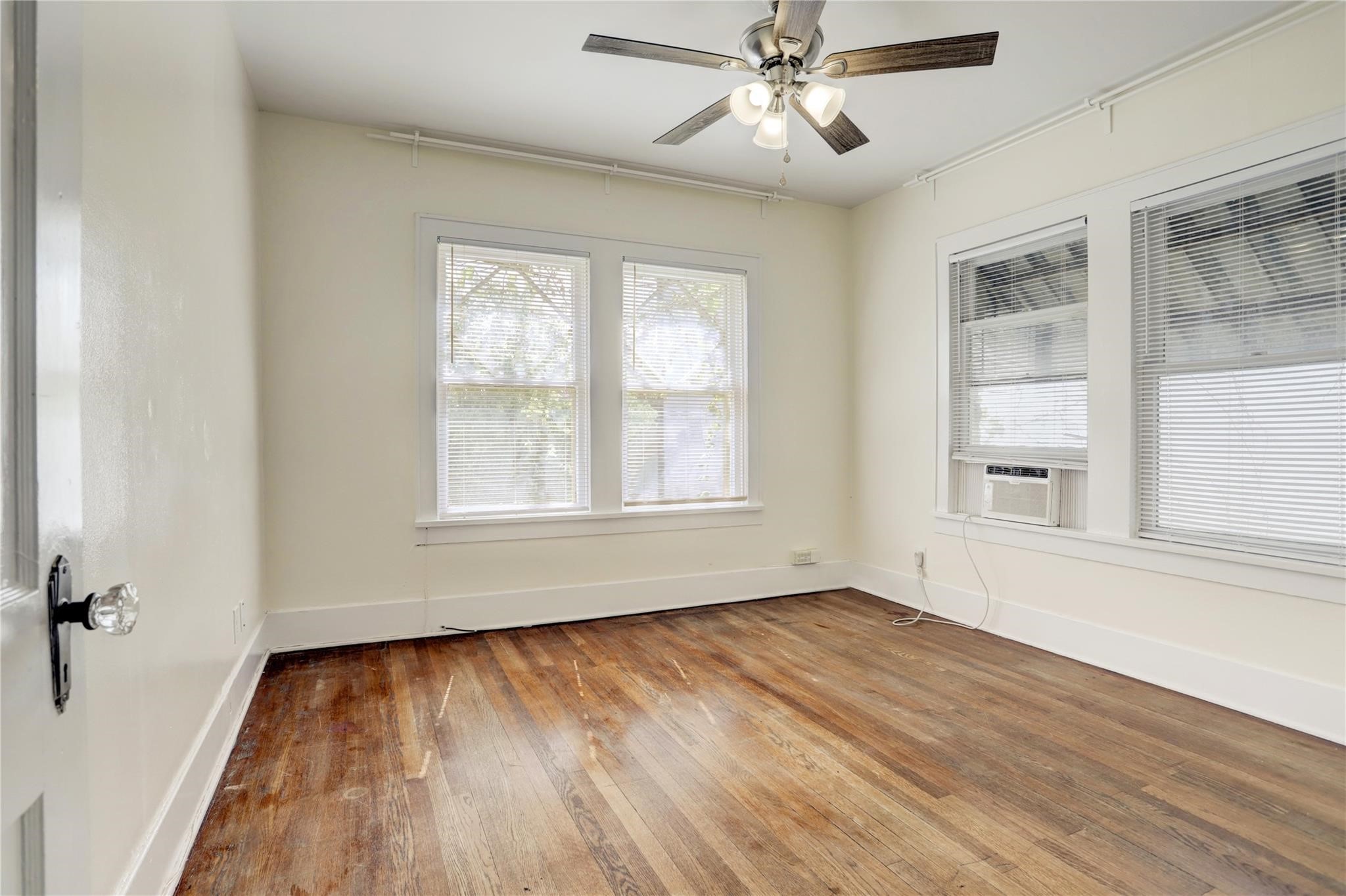 607 West Pierce Street Houston, TX 77019 - Photo 12 of 20 a view of an empty room with wooden floor and a window