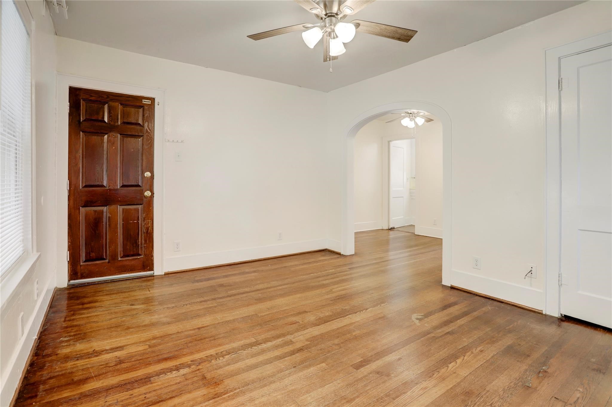 607 West Pierce Street Houston, TX 77019 - Photo 6 of 20 wooden floor in an empty room with a window
