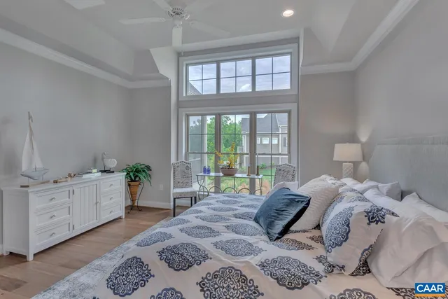 a bedroom with a bed and a large window