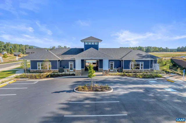 a front view of a house with yard swimming pool and outdoor seating