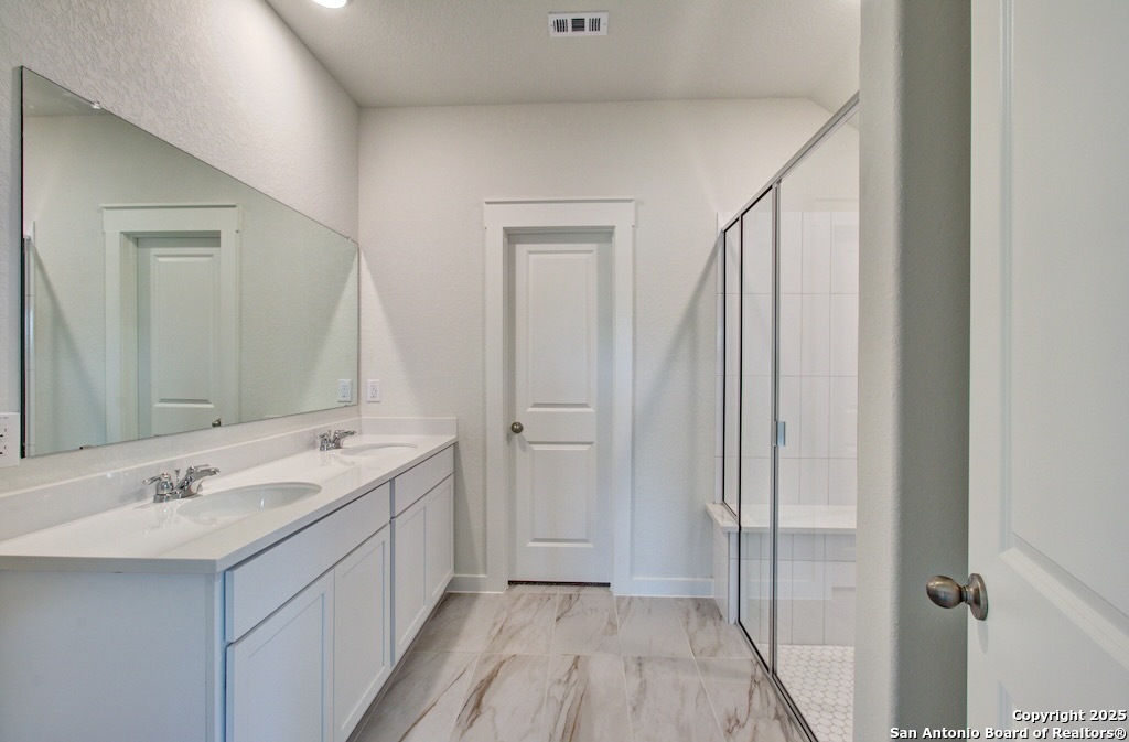 3625 Meteor Road New Braunfels, TX 78130 - Photo 14 of 39 a bathroom with a double vanity sink and mirror