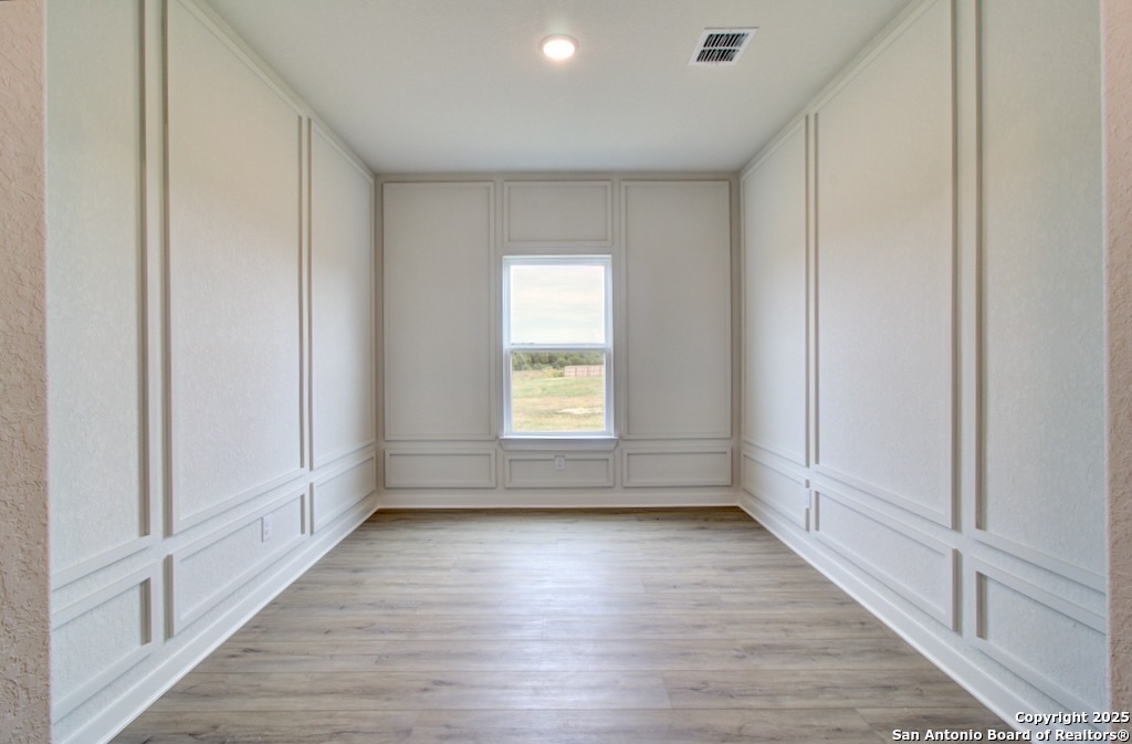 3625 Meteor Road New Braunfels, TX 78130 - Photo 19 of 39 a view of empty room with wooden floor and fan